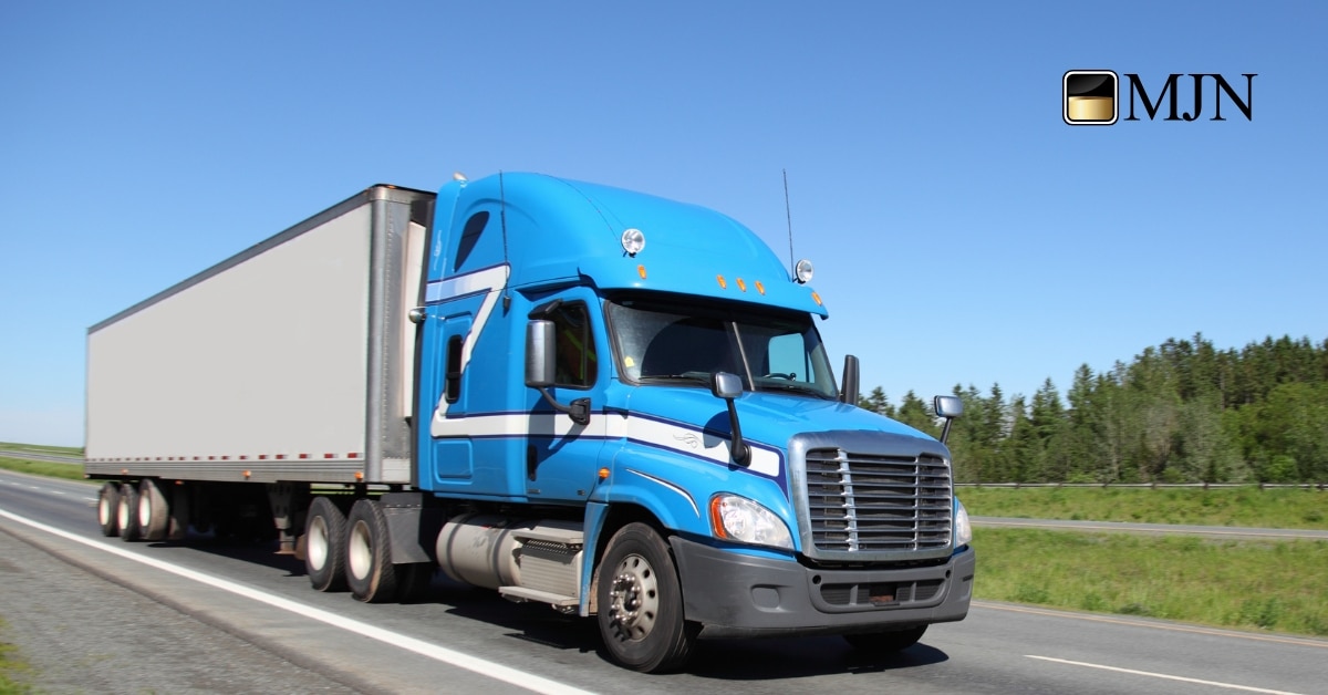 Semi-truck on highway representing reliable transport and logistics services.