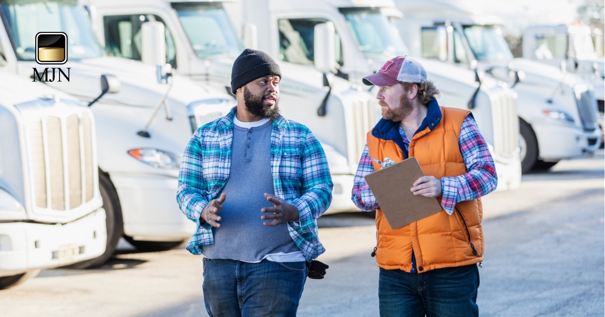 Truck driver reviewing freight invoices for factoring